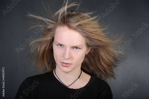 Photo: Long hair boy with streaming hair in photo studio Long hair boy with streaming hair in photo studio