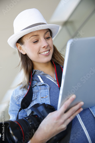 Photo: Smiling photographer using digital tablet Smiling photographer using digital tablet