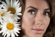 Portrait of a beautiful girl with daisies