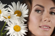 Portrait of a beautiful girl with daisies