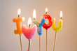 Colorful burning candles making 'I love you'