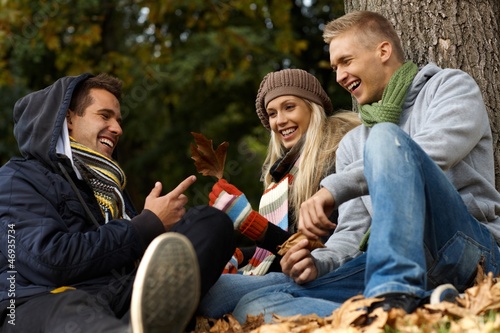 Photo: Happy companionship in autumn park Happy companionship in autumn park