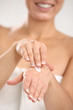 Close up of woman applying cream on her hand