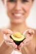 Beautiful woman portrait with fresh avocado in hand