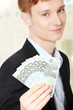 Photo: Young handsome businessman holding euros Young handsome businessman holding euros