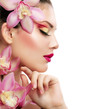 Beauty Portrait. Beautiful Stylish Girl with Orchid Flower