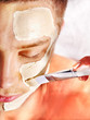 Clay facial mask in beauty spa.