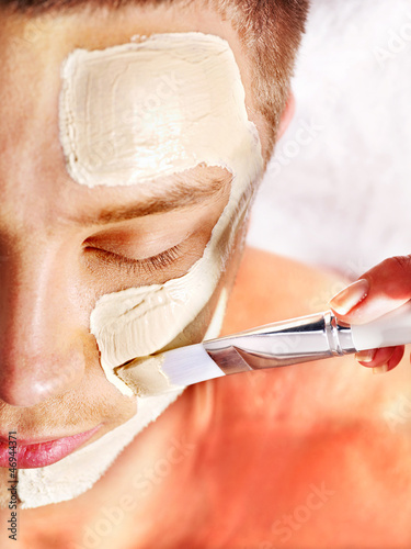 Photo: Clay facial mask in beauty spa. Clay facial mask in beauty spa.