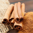 Cinnamon sticks and  powder in wooden scoop