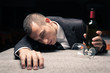 Foto: Young business man drunk felt asleep with red wine. Young business man drunk felt asleep with red wine.