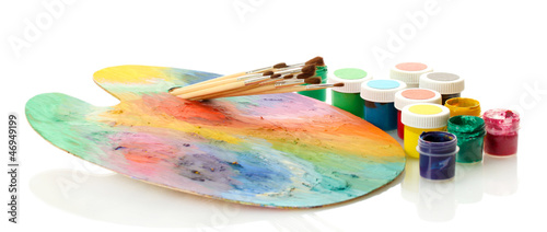 Photo: wooden art palette with paint and brushes isolated on white wooden art palette with paint and brushes isolated on white