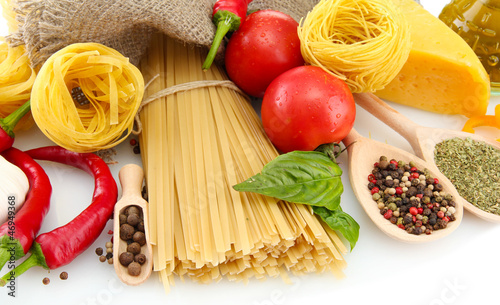 Photo: Pasta spaghetti, vegetables and spices, isolated on white Pasta spaghetti, vegetables and spices, isolated on white