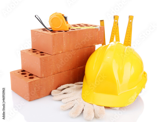 Photo: helmet, roulette, bricks and gloves isolated on white helmet, roulette, bricks and gloves isolated on white