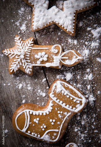 Photo: Traditional gingerbread cookies over wooden background Traditional gingerbread cookies over wooden background