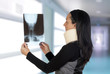 Woman with cervical collar looking her radiography