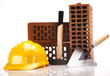 Brick, yellow hard hat, tools