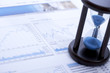 Hourglass on financial paper, close up