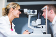 Photo: optometry concept - handsome young man having her eyes examined optometry concept - handsome young man having her eyes examined