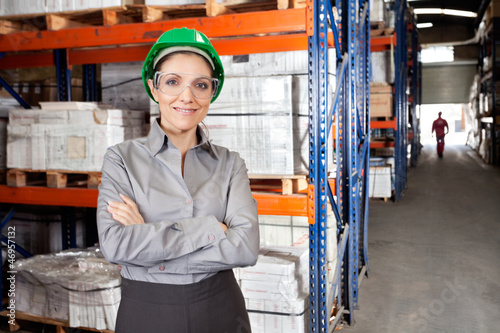 Photo: Female Supervisor Wearing Protective Eyeglasses At Warehouse Female Supervisor Wearing Protective Eyeglasses At Warehouse