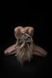 Naked blonde on a black background