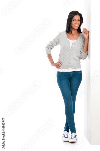 Photo: Happy latin girl standing on wall Happy latin girl standing on wall