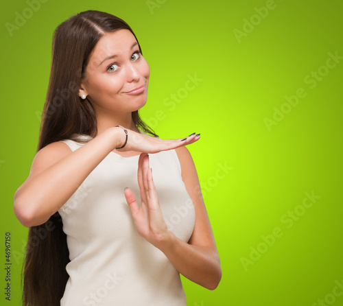 Photo: Portrait Of Young Woman Showing Time Out Signal Portrait Of Young Woman Showing Time Out Signal