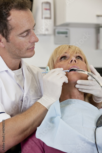 Photo: A female patient having an x-ray at the dentists A female patient having an x-ray at the dentists