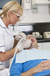 Photo: A female dentist treating her male patient A female dentist treating her male patient