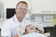 A male dentist working on a young boy patients teeth