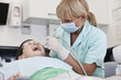 A female dental nurse/hygienist working on a young boy patient