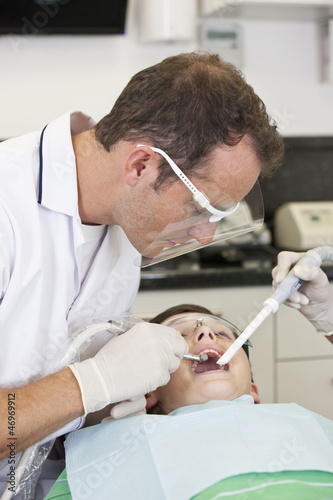Photo: A young boy patient having dental treatment, close up A young boy patient having dental treatment, close up