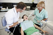 A young boy patient having dental treatment, looking scared