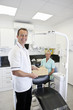 A male dentist and female nurse in a dental surgery