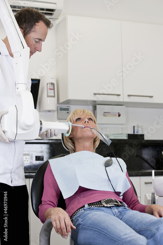 Photo: A female patient having an x-ray at the dentist A female patient having an x-ray at the dentist