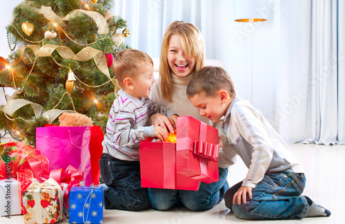 Photo: Happy Children with Christmas gifts Happy Children with Christmas gifts
