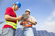two workers  discussing with tablet pc before  solar power stat