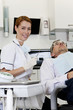 A female dentist with a male patient