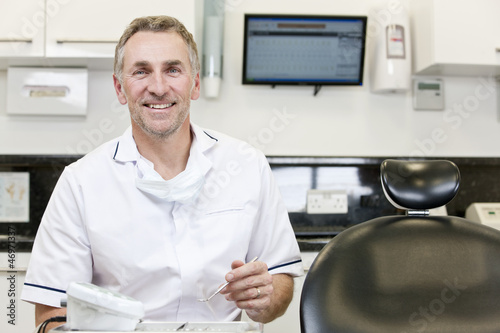 Photo: A male dentist in a dental surgery A male dentist in a dental surgery