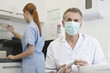 A male dentist and female dental nurse in a dental surgery