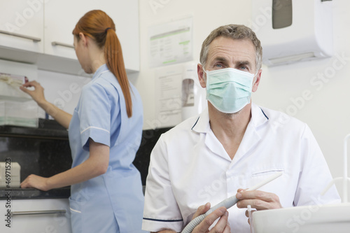 Photo: A male dentist and female dental nurse in a dental surgery A male dentist and female dental nurse in a dental surgery