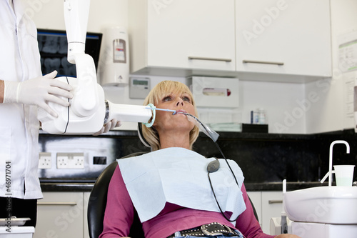 Photo: A female patient having an x-ray at the dentist A female patient having an x-ray at the dentist