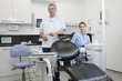 A male dentist and female dental nurse in a dental surgery