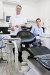 A male dentist and female dental nurse in a dental surgery