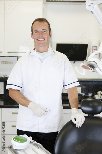 Photo: A male dentist in a dental surgery A male dentist in a dental surgery