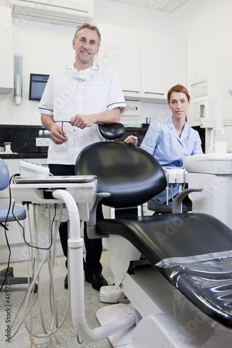Photo: A male dentist and female dental nurse in a dental surgery A male dentist and female dental nurse in a dental surgery