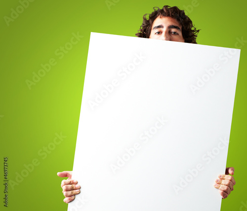 Photo: Portrait Of Man Holding a blank billboard Portrait Of Man Holding a blank billboard