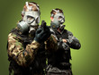 Portrait Of Soldiers With Gun And Gas Mask