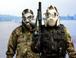Portrait Of Soldiers With Gun And Gas Mask