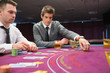 Photo: Man placing bet in poker game Man placing bet in poker game