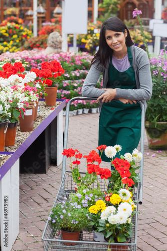 Photo: Garden center employee pushing trolley Garden center employee pushing trolley